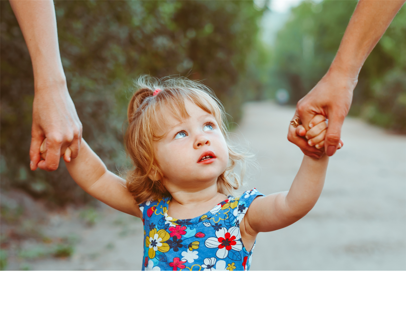 Child holding parents hands